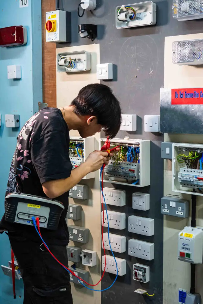 a male electrical student in workshop