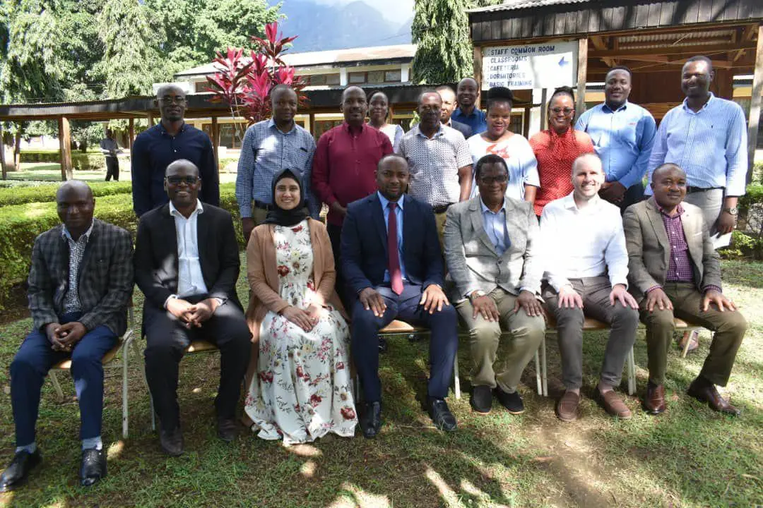 Sabrina Ahmed-Qureshi and Richard Roberts pose with hosts during the visit to Tanzania