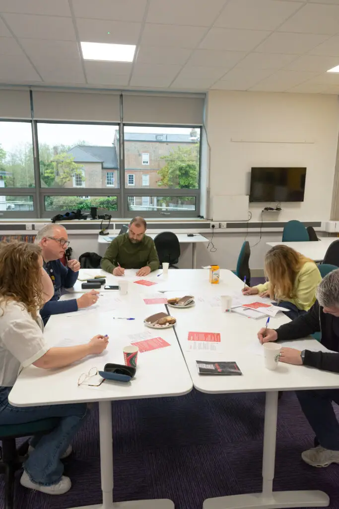 Group of people at a table writing