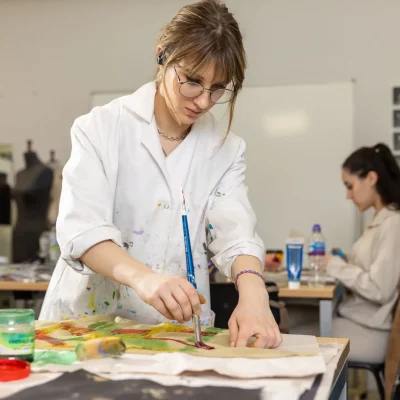 a female art student painting with watercolours